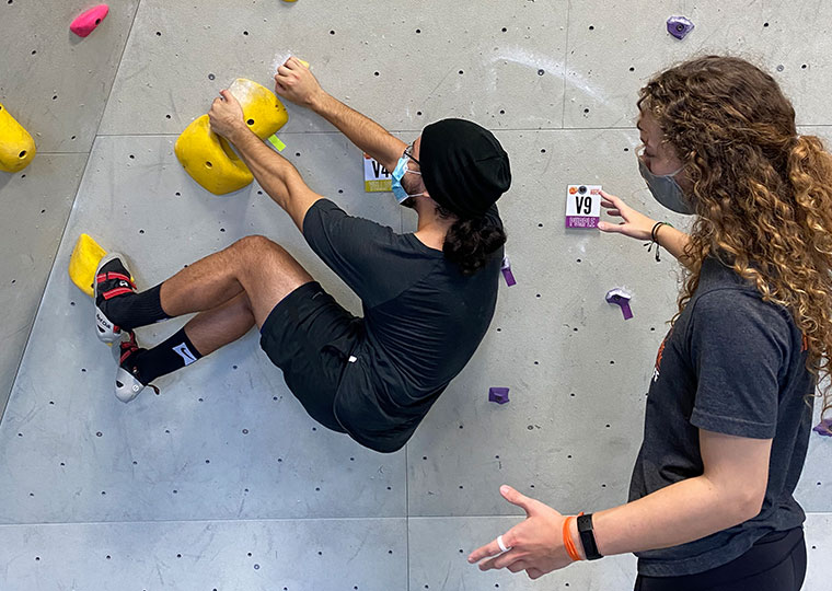 instructor assisting a climber on his movements