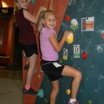 two young girls rock climbing