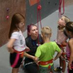 kids listening to their instructor before climbing