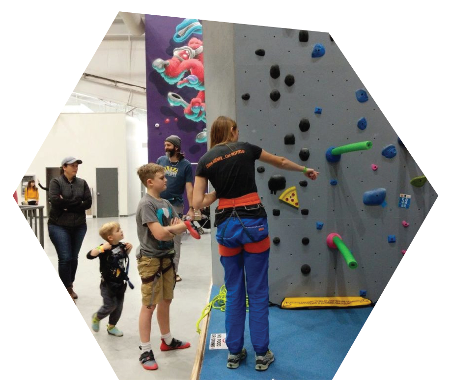 instructor giving instructions to a young climber