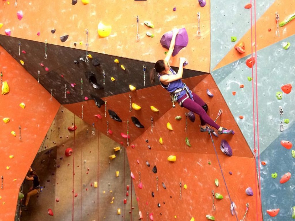 woman climbing a wall