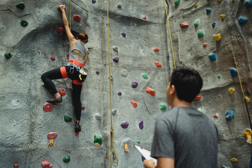 climber being guided by a coach