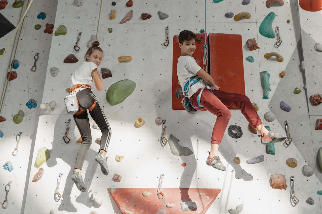 a boy and a girl climbing