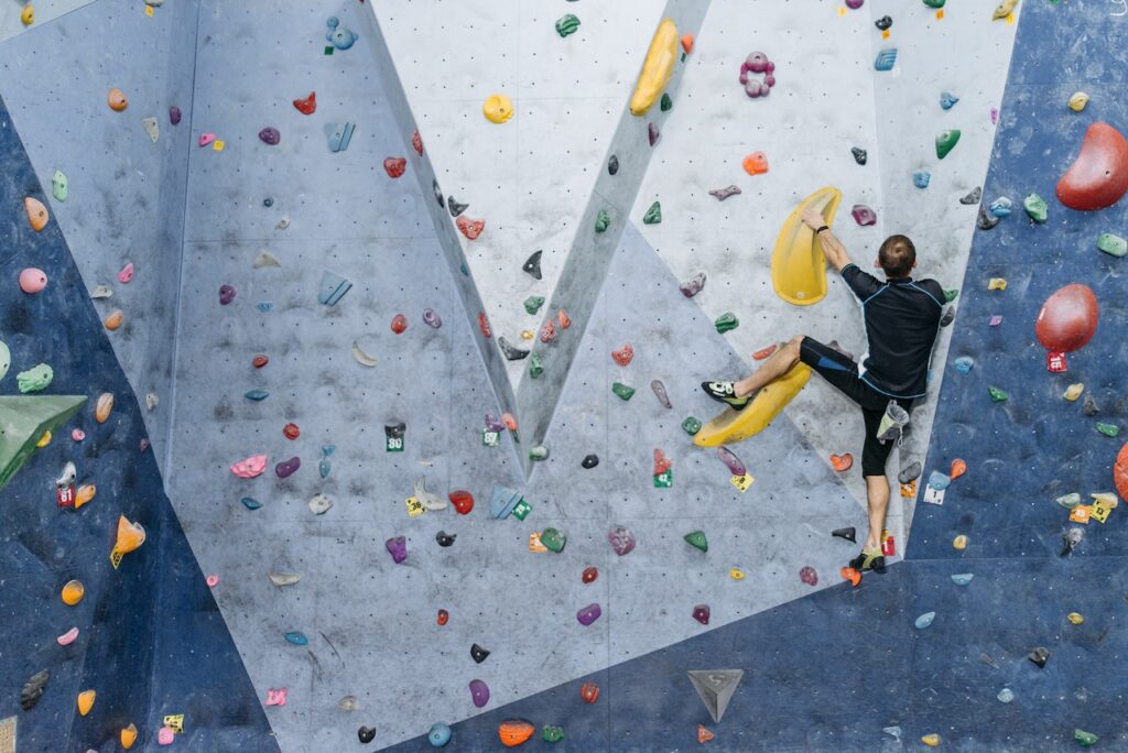 male climber climbing a wall