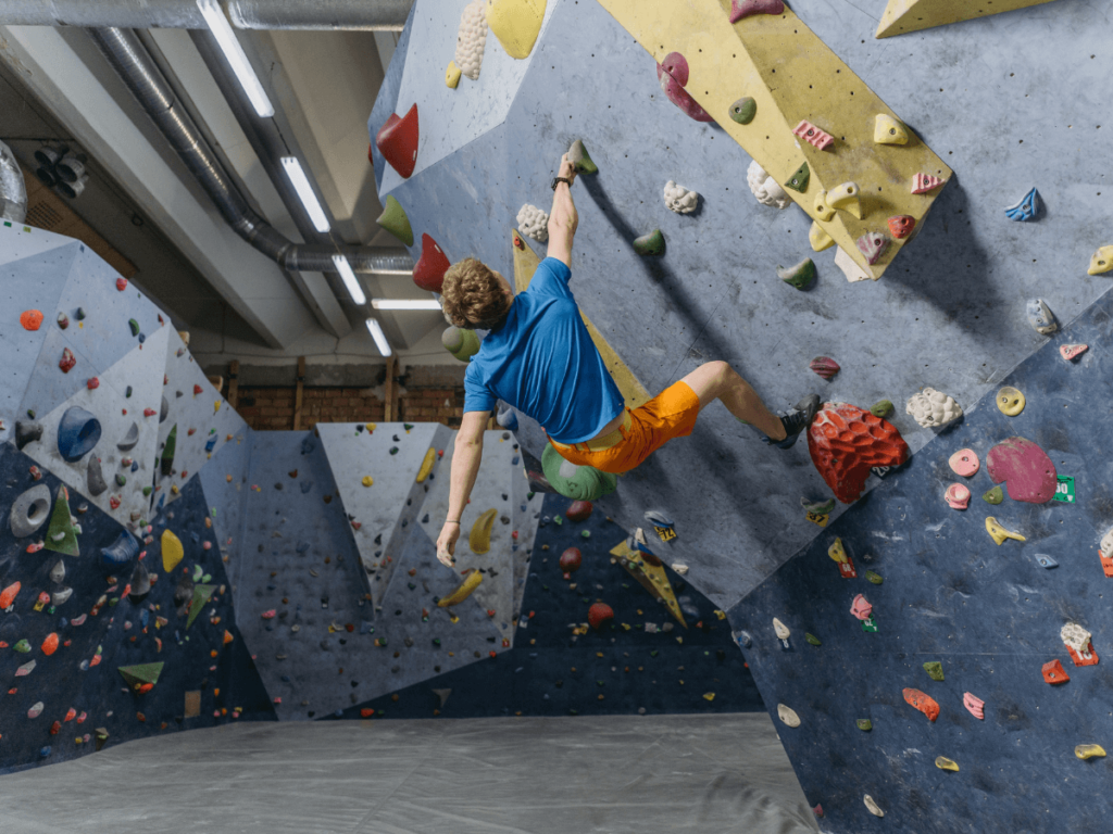 male climber in climbing an indoor wall