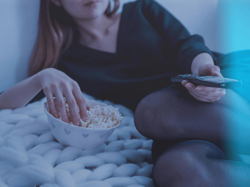 woman eating popcorn while watching a movie